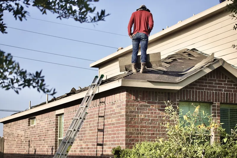 Professional roofer working on a residential roof in Sunridge Canyon